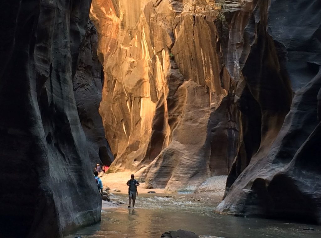Early morning and you’re knee-deep in clear water, surrounded by sheer walls of red rock with only a breeze for company.