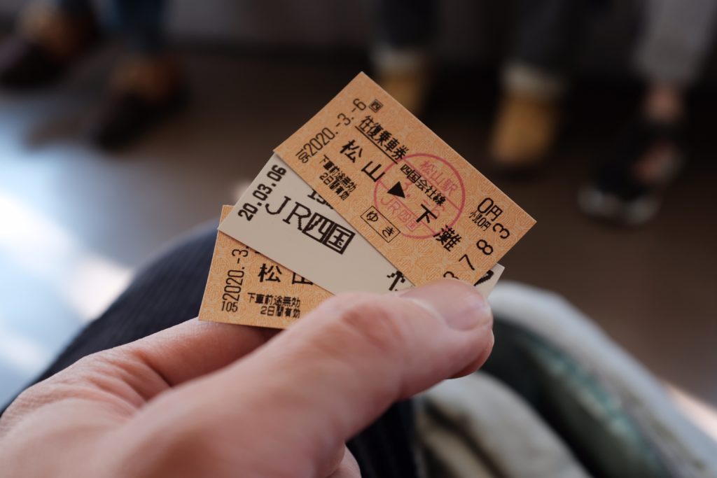 Train tickets held by a person