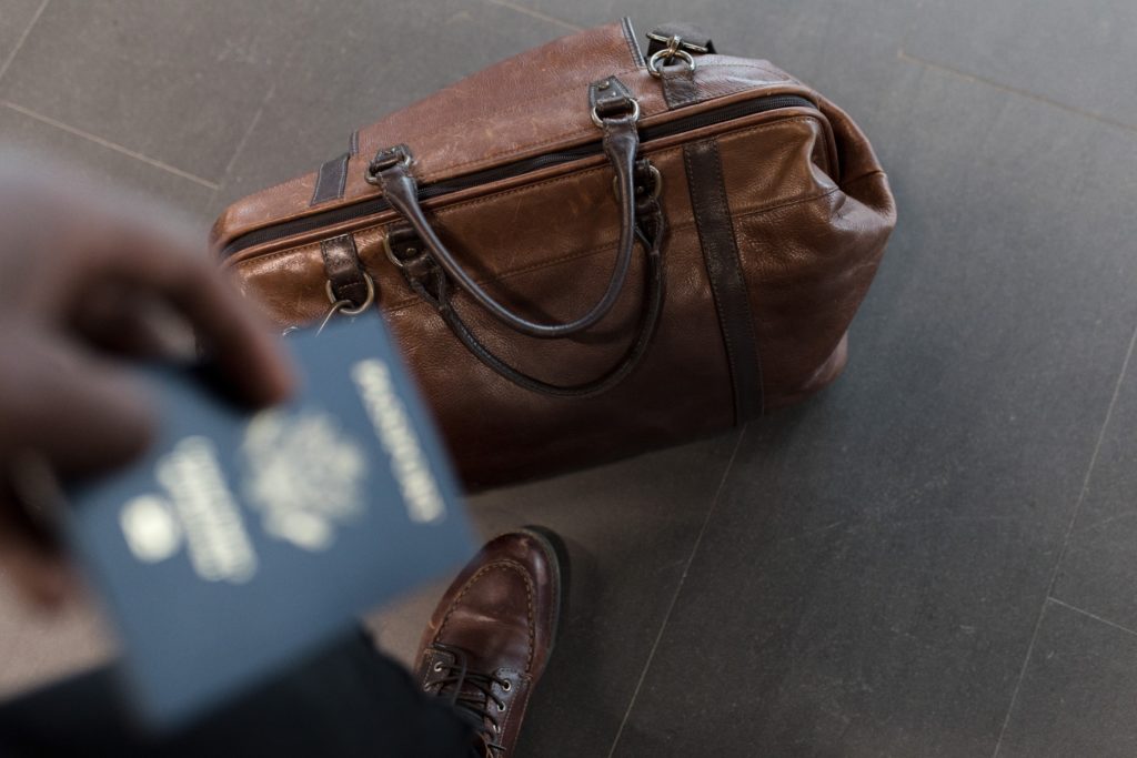 Traveler with bag and passport