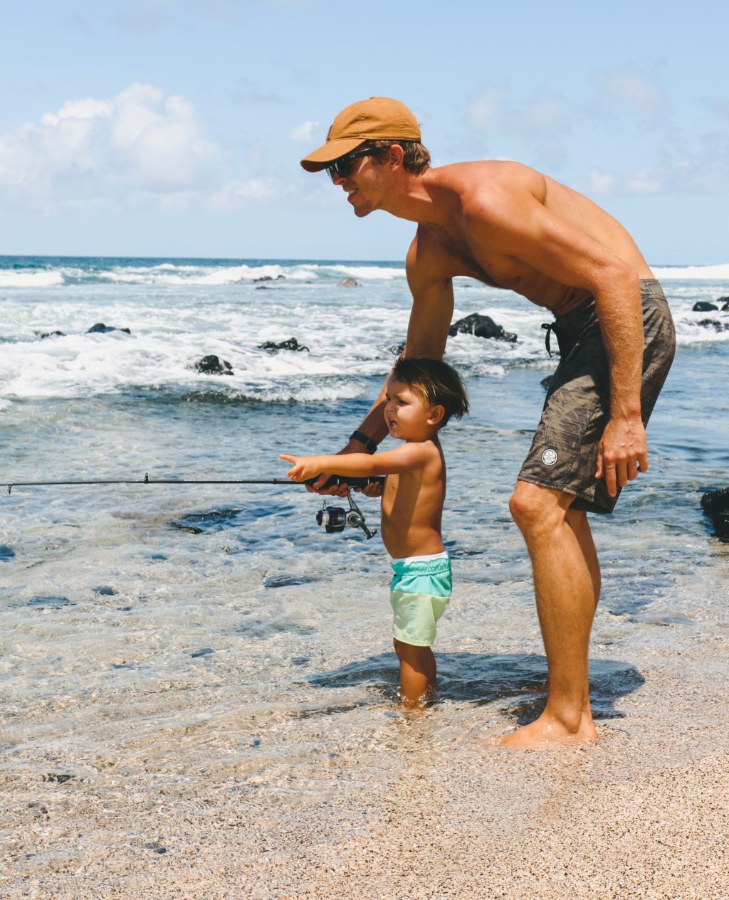 Father and son fishing on a beach