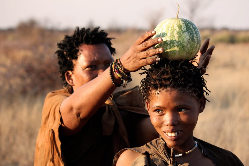 Village women with joyful smiles at an African campsite in the Botswana bush.