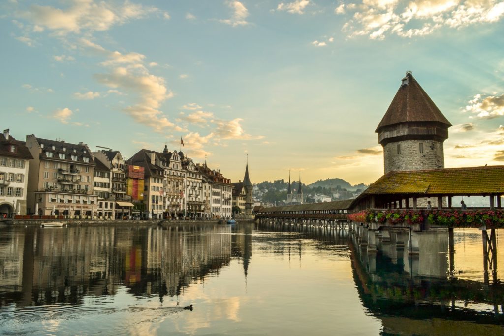 Luzerner Bridge bathed in the warm glow of late evening light, capturing the tranquil ambiance just before sunset.