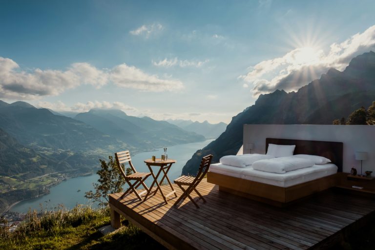 A bed placed outdoors offers a serene setting with a captivating view of Lake Wallensee. Switzerland