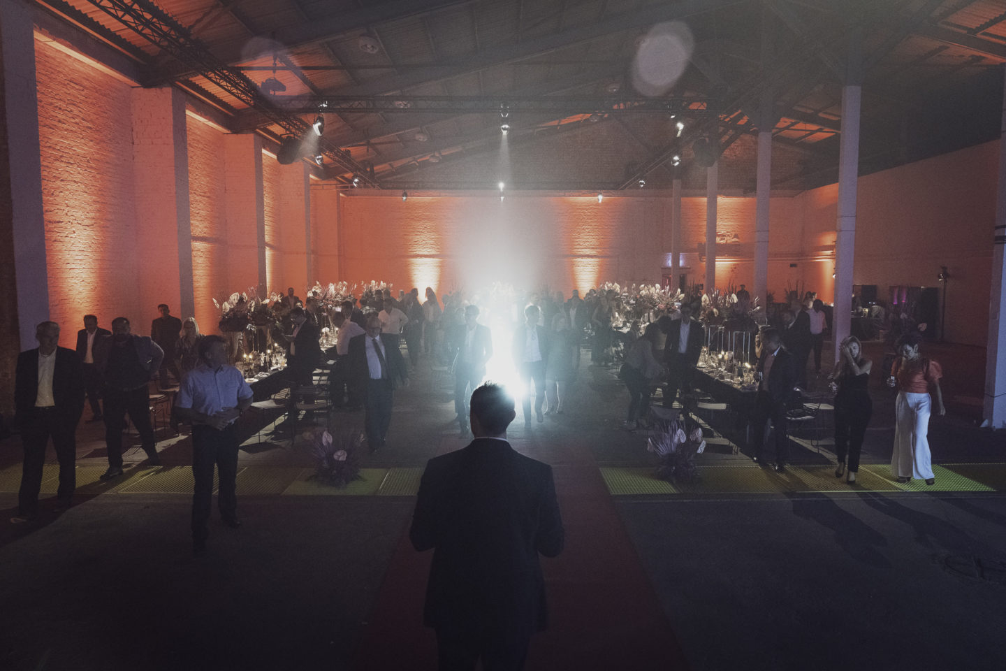 The head of the company gives a speech during a corporate event in a cool urban location in Berlin, Germany.