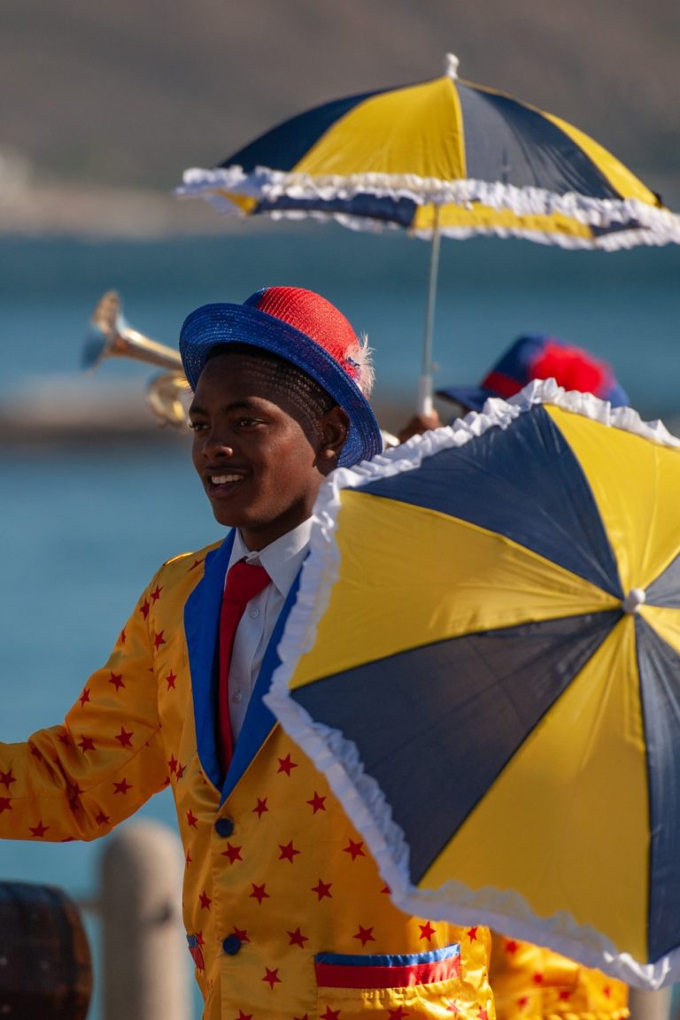 Boy holding a colorful umbrella in Cape Town.