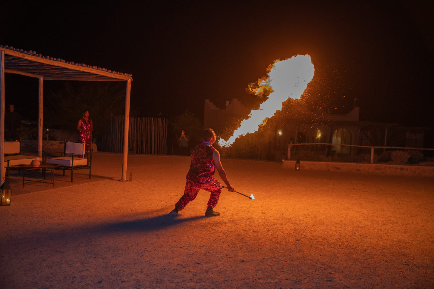 A fire-eater thrills guests during an event in the Moroccan desert.