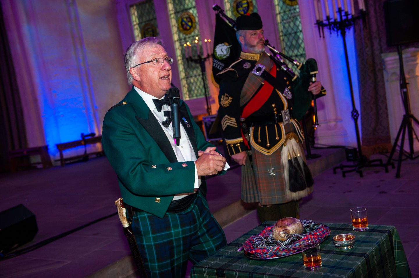 The Master of Ceremonies delivers the address to a Haggis during a dinner at Stirling Castle in Scotland.