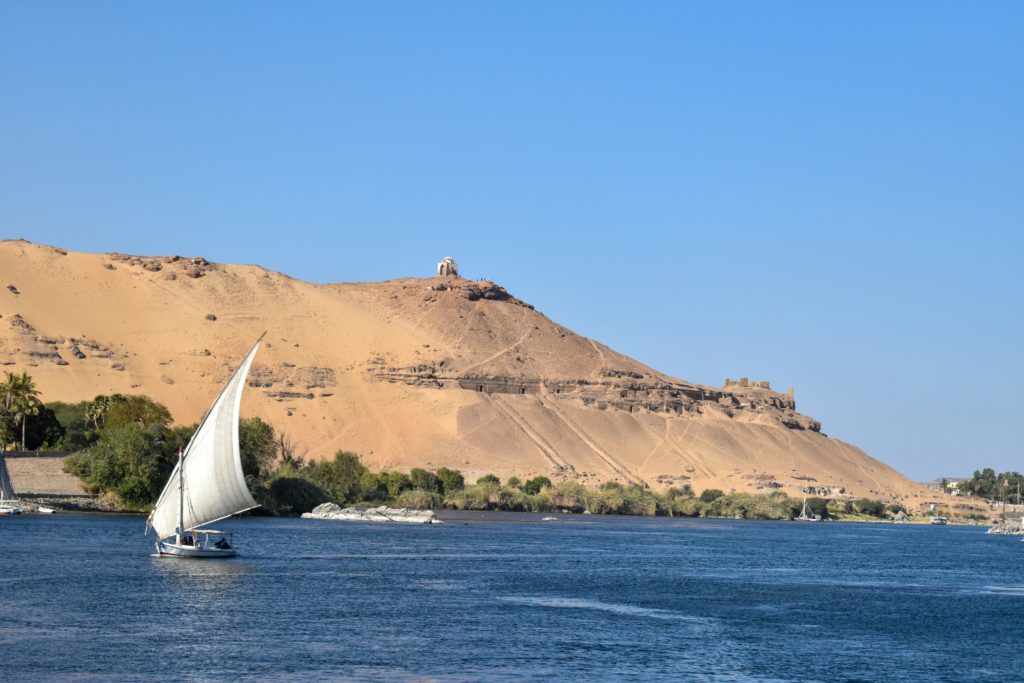 A sailing boat floats gently across the Nile.