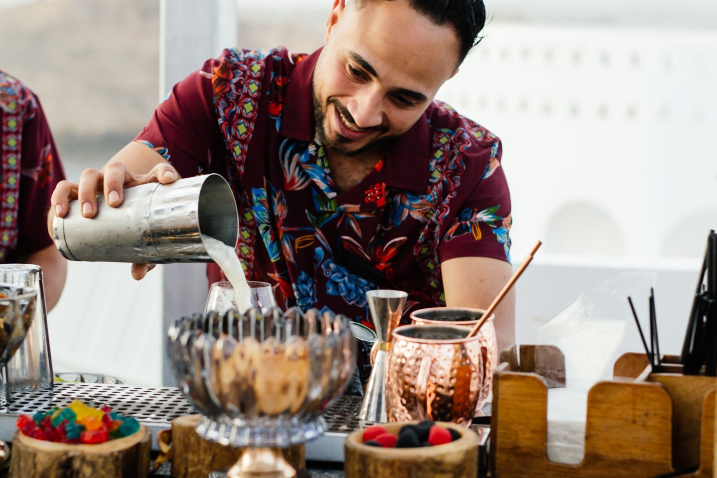 The bartender smilingly mixes drinks for guests during a private event in Egypt.