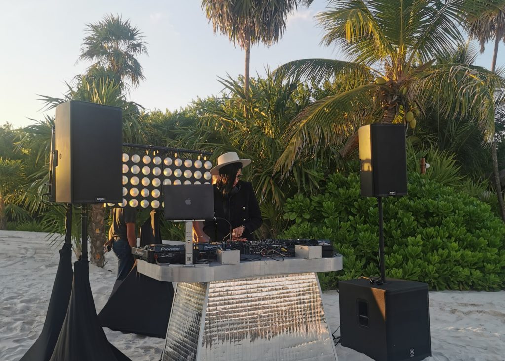 The DJ is set up right on the beach during an event in Mexico.