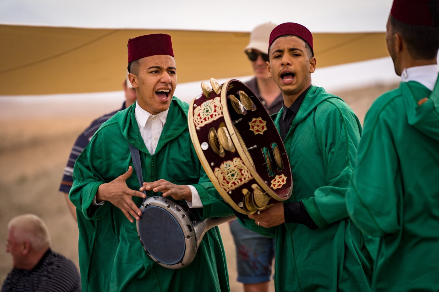 A group of young men play local Berber music during an event in the Moroccan desert.
