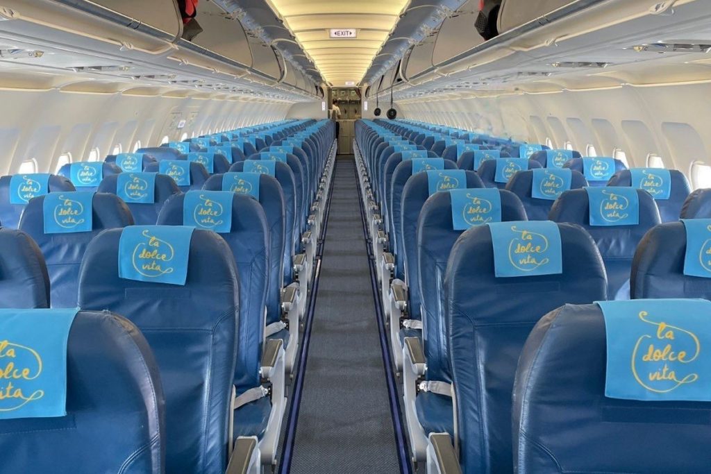 The branded headrest covers can be seen on the chartered aircraft that brought the group to the private event in Puglia, Italy.