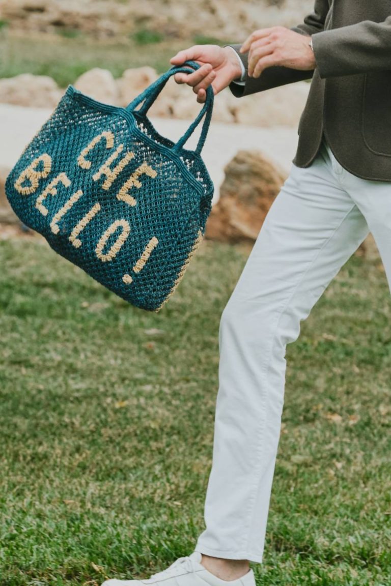 A stylish woman walks across the lawn during a private event in Puglia, Italy.